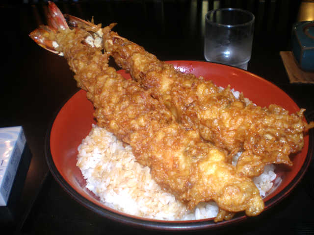 丼からはみ出した巨大な海老の天ぷらが２本。